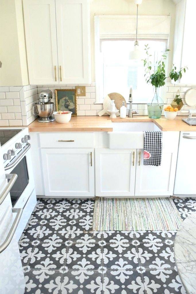 White marble tiles add to the light and airy feel in this compact kitchen