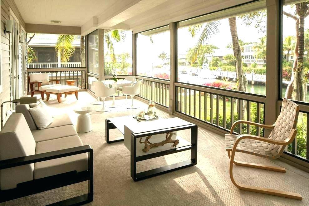 The Tobago Outdoor Collection, outdoor curtains and a patterned rug turn this screened in porch into an outdoor living room