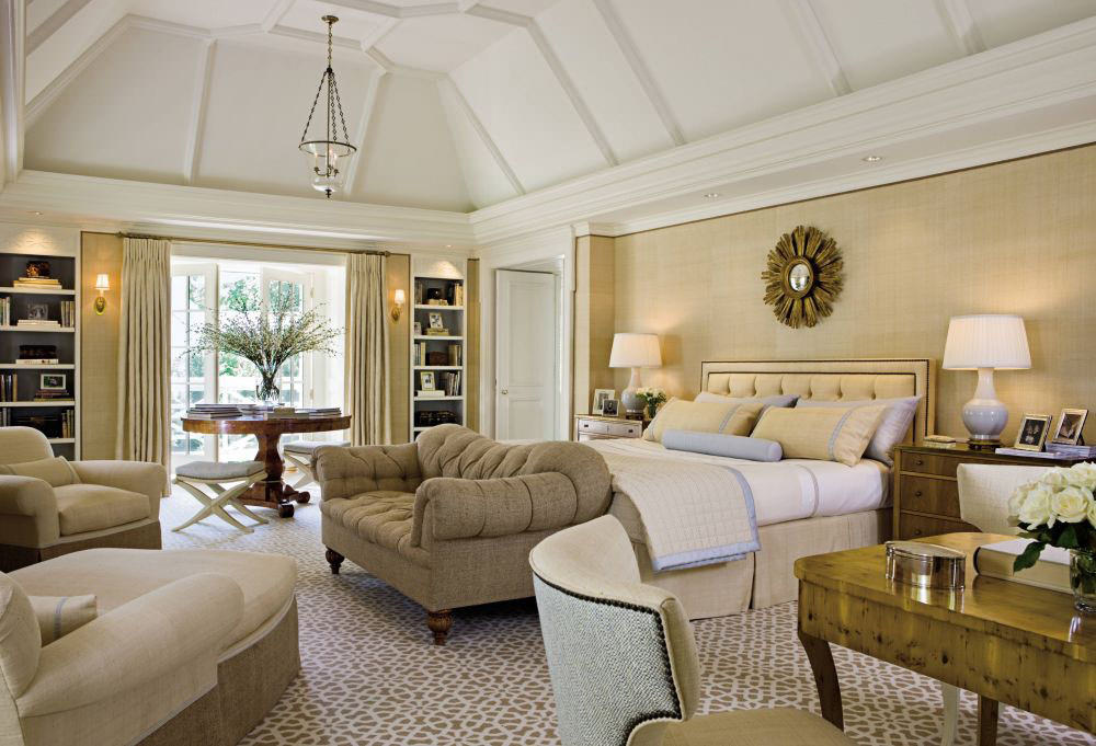 A beautiful living room in classical interior design style with floral  prints on the wall and a charming round golden mirror