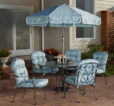 A set of matching garden furniture with blue cushions