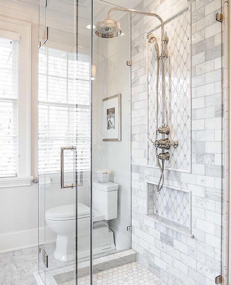 A double shower covered in really large marble tiles